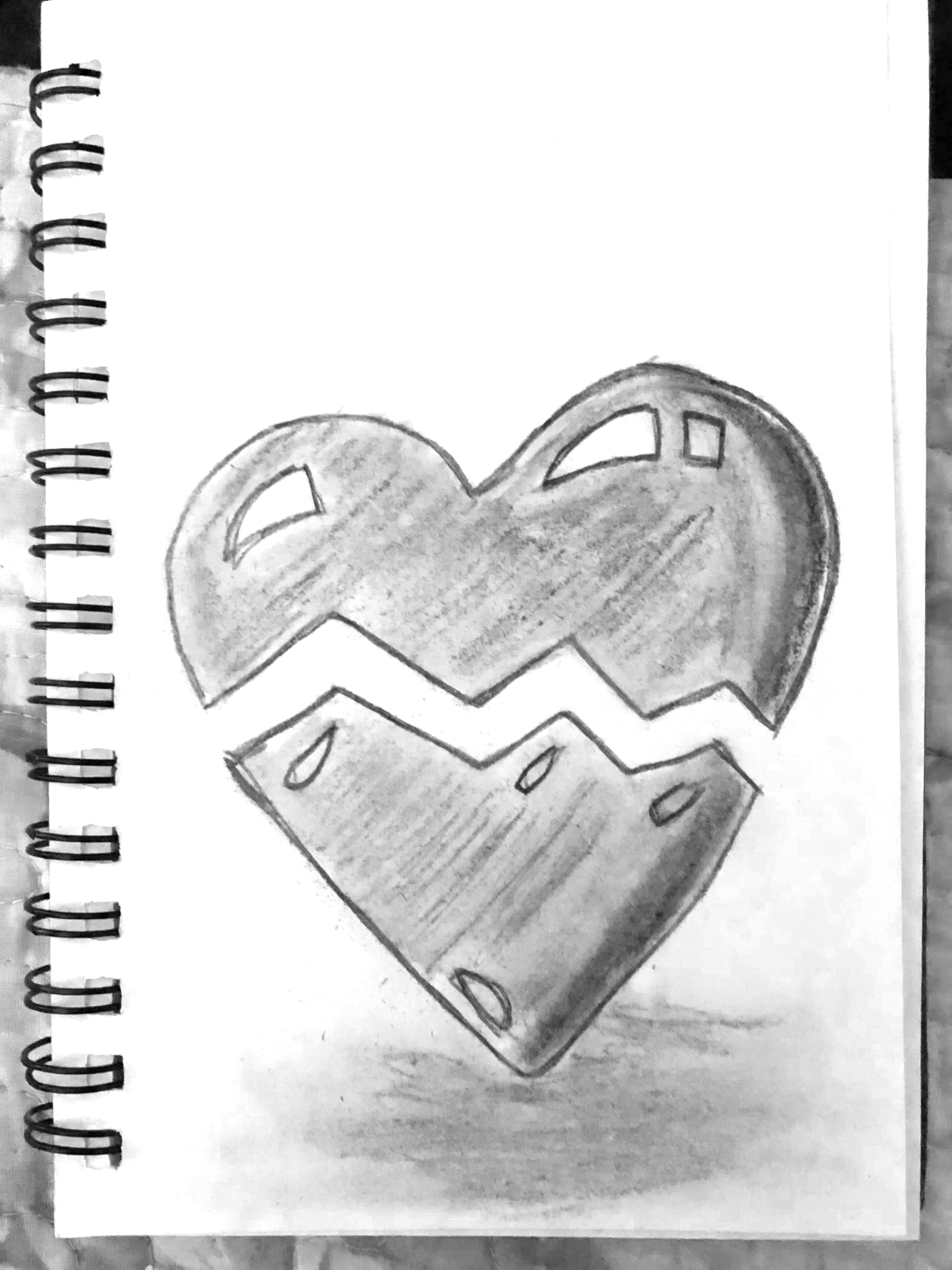 Charcoal drawing of a heart broken in half