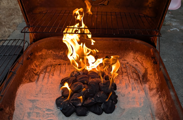 Coals on fire inside a barbecue